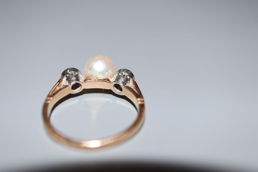 A yellow metal, single cultured pearl and two stone diamond ring, size K/L, gross 3.9 grams.